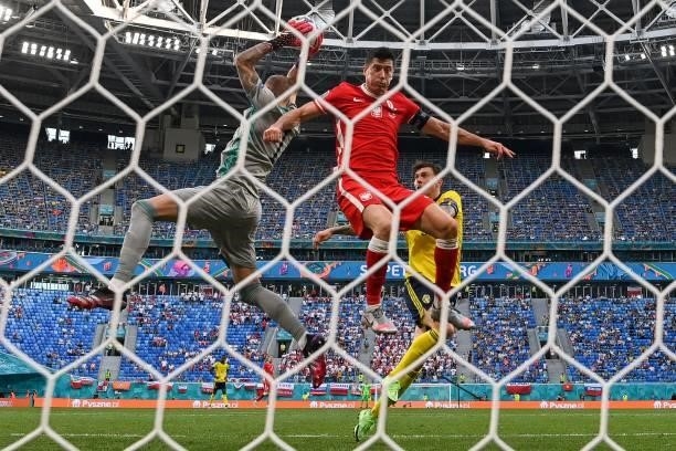 Sweden's goalkeeper Robin Olsen catches the ball as Poland's forward Robert Lewandowski jumps during the UEFA EURO 2020 Group E football match...