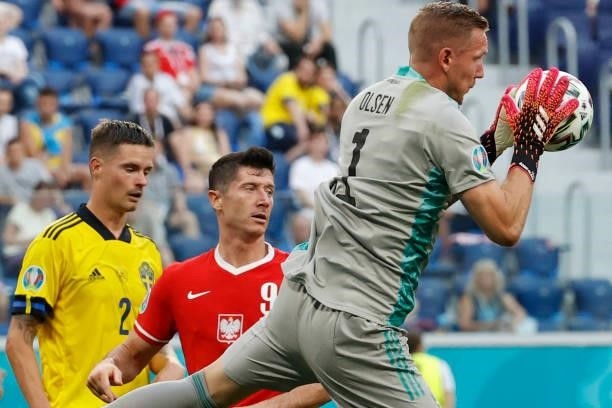 Sweden's goalkeeper Robin Olsen catches the ball next to Poland's forward Robert Lewandowski during the UEFA EURO 2020 Group E football match between...