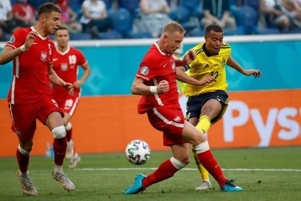 Sweden's midfielder Robin Quaison kicks the ball past Poland's defender Kamil Glik during the UEFA EURO 2020 Group E football match between Sweden...