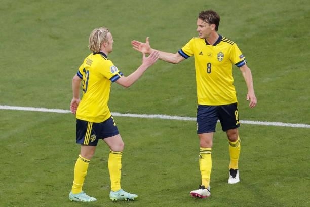 Sweden's midfielder Emil Forsberg celebrates with Sweden's midfielder Albin Ekdal after scoring his team's second goal during the UEFA EURO 2020...
