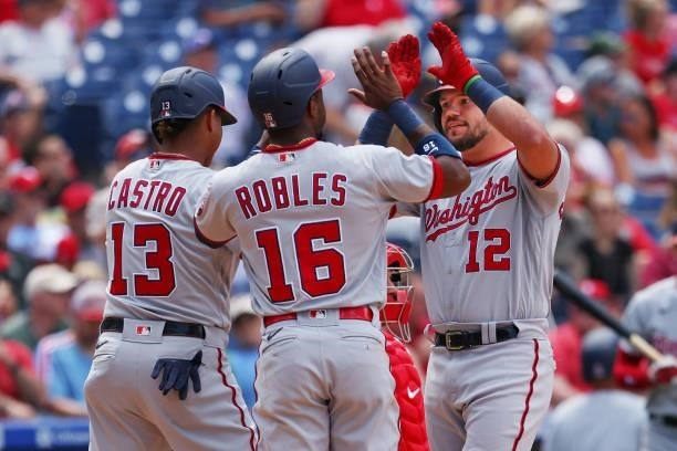 Kyle Schwarber of the Washington Nationals is congratulated by Starlin Castro and Victor Robles after he hit a three-run home run against the...