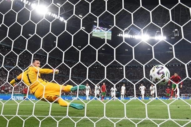 France's goalkeeper Hugo Lloris concedes the opening goal scored by Portugal's forward Cristiano Ronaldo from the penalty spot during the UEFA EURO...
