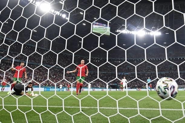Portugal's goalkeeper Rui Patricio concedes France's second goal scored by France's forward Karim Benzema during the UEFA EURO 2020 Group F football...