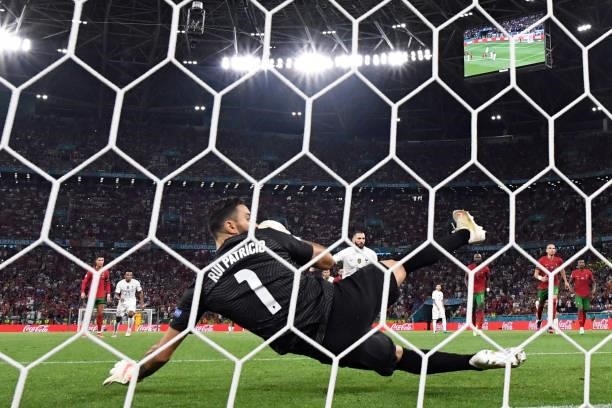France's forward Karim Benzema shoots and scores from the penalty spot past Portugal's goalkeeper Rui Patricio during the UEFA EURO 2020 Group F...