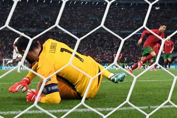 Portugal's forward Cristiano Ronaldo scores the team's second goal from the penalty spot past France's goalkeeper Hugo Lloris during the UEFA EURO...