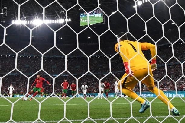 Portugal's forward Cristiano Ronaldo scores the team's second goal from the penalty spot during the UEFA EURO 2020 Group F football match between...