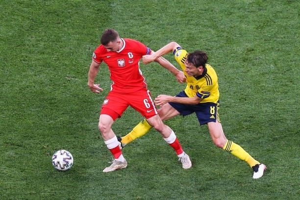 Kacper Kozlowski and Albin Ekdal fight for the ball during the UEFA EURO 2020 Group E football match between Sweden and Poland at Saint Petersburg...