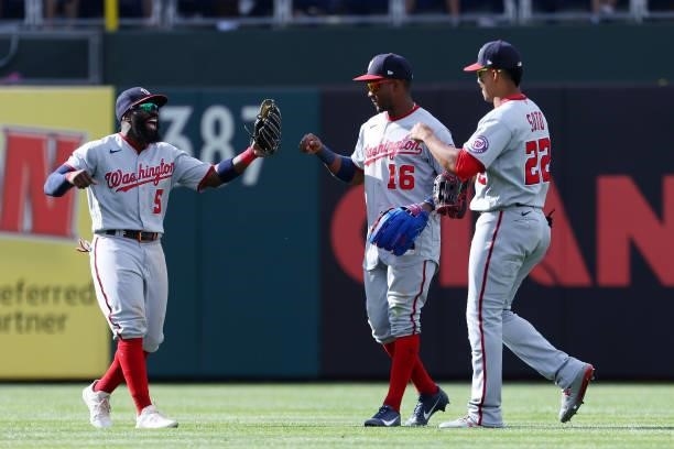 Outfielders Josh Harrison, Victor Robles and Juan Soto of the Washington Nationals celebrate their 13-12 win over the Philadelphia Phillies in a game...