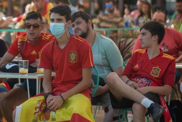 Spanish fans watch the UEFA Euro 2020 Championship Group E match between Slovakia and Spain in a bar on June 23, 2021 in Seville, Spain.