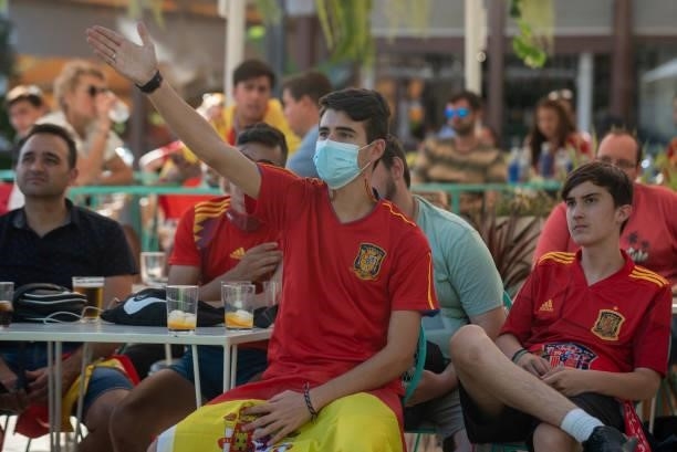 Spanish fans watch the UEFA Euro 2020 Championship Group E match between Slovakia and Spain in a bar on June 23, 2021 in Seville, Spain.