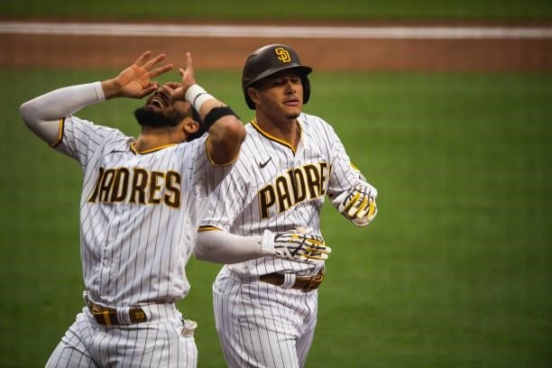 Manny Machado of the San Diego Padres celebrates with Fernando Tatis Jr after hitting a home run in the first inning against the Los Angeles Dodgers...