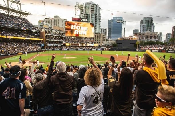 Fans cheer after Jake Cronenworth of the San Diego Padres hits a home run in the first inning against the Los Angeles Dodgers on June 23, 2021 at...