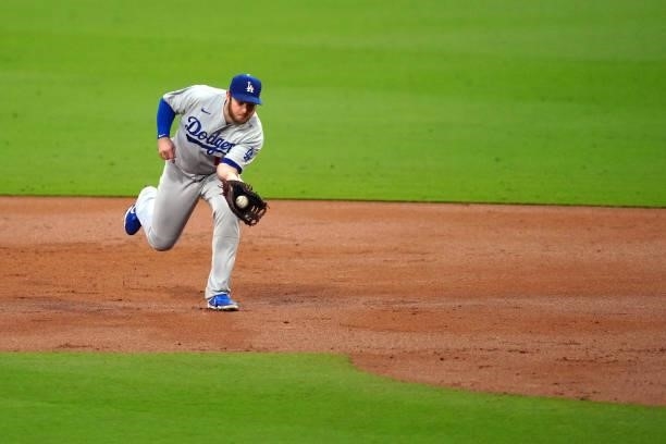 Max Muncy of the Los Angeles Dodgers fields the ball during the game between the Los Angeles Dodgers and the San Diego Padres at Petco Park on...