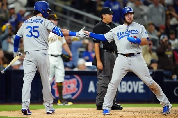 Cody Bellinger of the Los Angeles Dodgers celebrates with Max Muncy after Muncy tied the game during the game between the Los Angeles Dodgers and the...