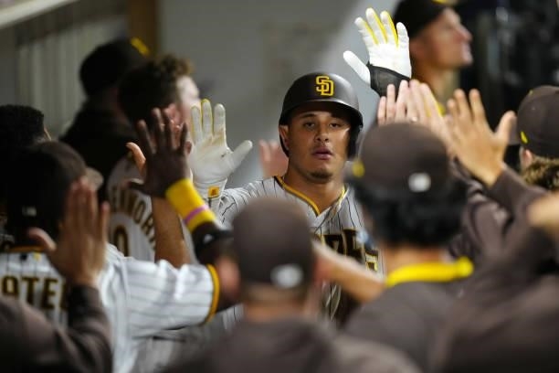 Manny Machado of the San Diego Padres celebrates scoring during the game between the Los Angeles Dodgers and the San Diego Padres at Petco Park on...