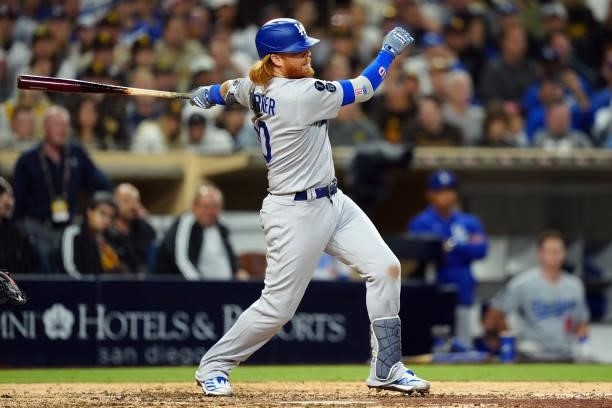 Justin Turner of the Los Angeles Dodgers hits an RBI single to tie the game during the game between the Los Angeles Dodgers and the San Diego Padres...