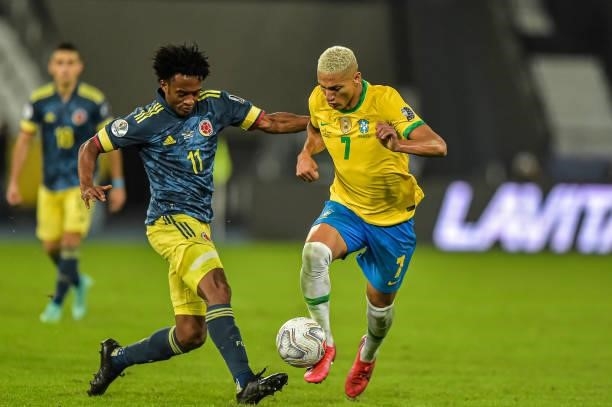 Richarlisson player from Brazil disputes a bid with Cuadrado player from Colombia during the Group B match between Brazil and Colombia as part of...