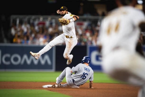 Fernando Tatis Jr of the San Diego Padres attempts to turn a double play in the fourth inning against the Los Angeles Dodgers on June 23, 2021 at...