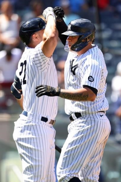 Gary Sanchez of the New York Yankees high fives Giancarlo Stanton after he hit a three-run home run against the Kansas City Royals during the sixth...