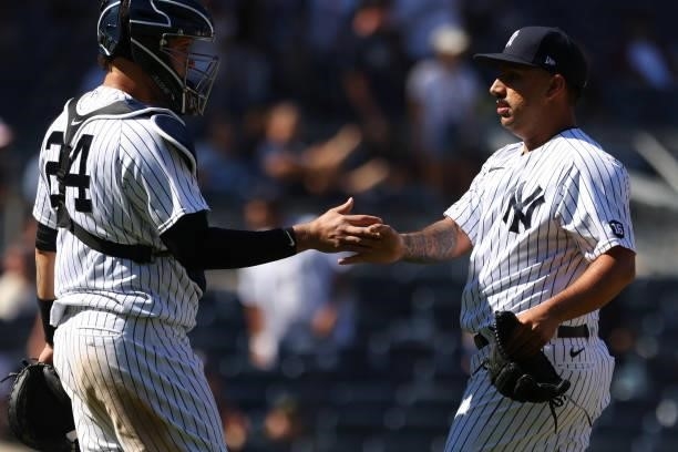 Catcher Gary Sanchez and pitcher Nestor Cortes of the New York Yankees shake hands after defeating the Kansas City Royals 8-1 in a game at Yankee...