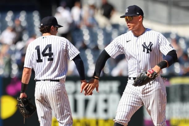 Tyler Wade and Aaron Judge of the New York Yankees shake hands after defeating the Kansas City Royals 8-1 in a game at Yankee Stadium on June 24,...