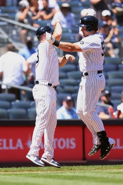 Luke Voit of the New York Yankees celebrates with third base coach Phil Nevin after he hit a home run against the Kansas City Royals during the third...