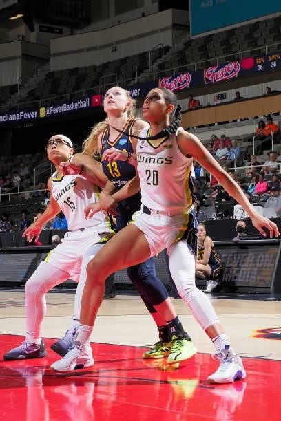Allisha Gray and Isabelle Harrison of the Dallas Wings and Lauren Cox of the Indiana Fever look up on June 24, 2021 at Indiana Farmers Coliseum in...