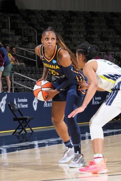 Tiffany Mitchell of the Indiana Fever handles the ball against Tyasha Harris of the Dallas Wings on June 24, 2021 at Indiana Farmers Coliseum in...
