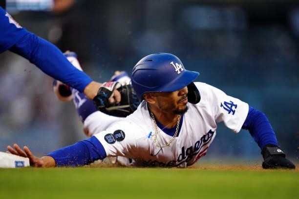 Mookie Betts of the Los Angeles Dodgers is tagged out at first base during the game between the Chicago Cubs and the Los Angeles Dodgers at Dodgers...