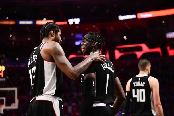Paul George of the LA Clippers talks to Reggie Jackson of the LA Clippers during the game against the Phoenix Suns during Game 3 of the Western...
