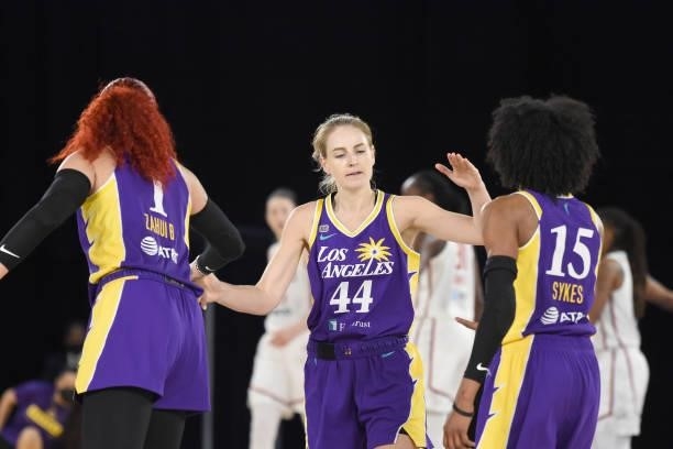 Karlie Samuelson of the Los Angeles Sparks high fives teammates Amanda Zahui B and Brittney Sykes during the game against the Washington Mystics on...