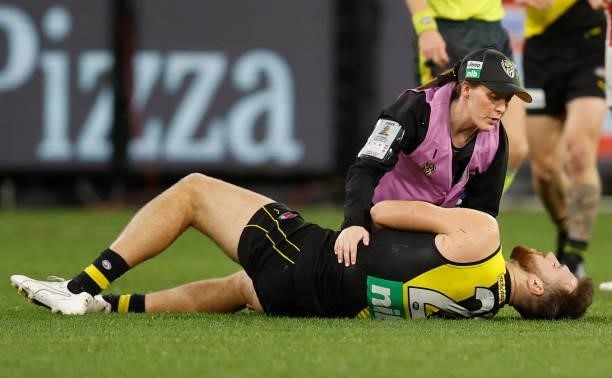 Noah Balta of the Tigers lays injured during the 2021 AFL Round 15 match between the Richmond Tigers and the St Kilda Saints at the Melbourne Cricket...