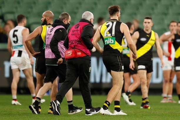 Noah Balta of the Tigers leaves the field injured during the 2021 AFL Round 15 match between the Richmond Tigers and the St Kilda Saints at the...