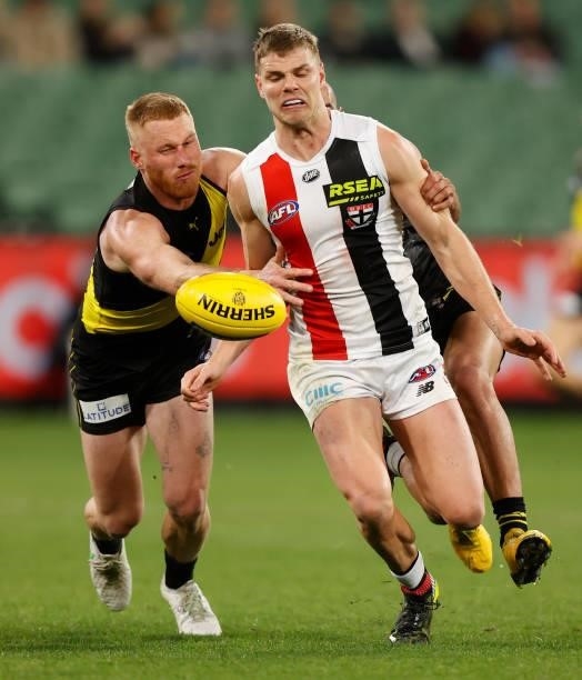 Mason Wood of the Saints is tackled by Nick Vlastuin of the Tigers during the 2021 AFL Round 15 match between the Richmond Tigers and the St Kilda...
