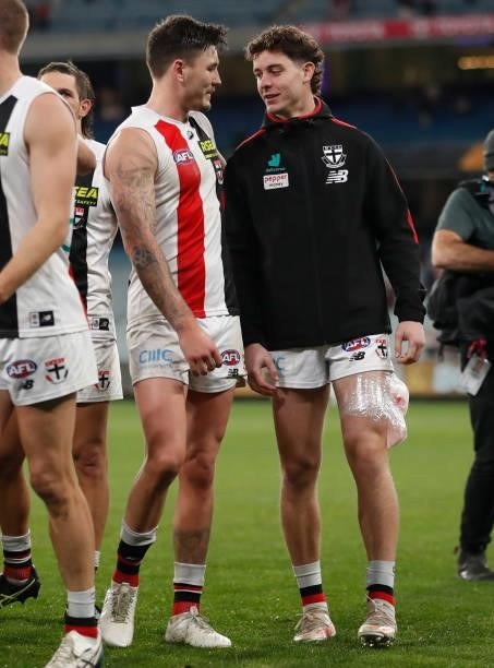 Josh Battle of the Saints and Nick Coffield of the Saints chat after the 2021 AFL Round 15 match between the Richmond Tigers and the St Kilda Saints...