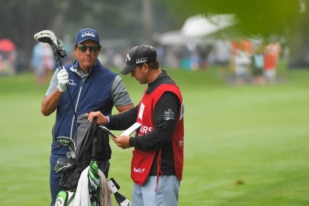 Phil Mickelson pulls a club from his bag on the sixth fairway during the second round of the Travelers Championship at TPC River Highlands on June...