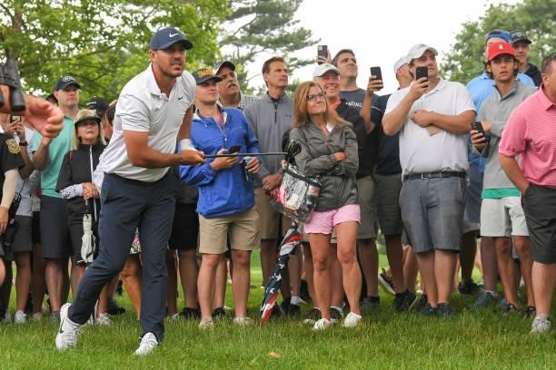 Brooks Koepka hits his ball from the rough on the sixth hole during the second round of the Travelers Championship at TPC River Highlands on June 25,...