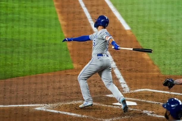 Whit Merrifield of the Kansas City Royals hits a run scoring triple in the top of the 3rd of the game against the Texas Rangers at Globe Life Field...