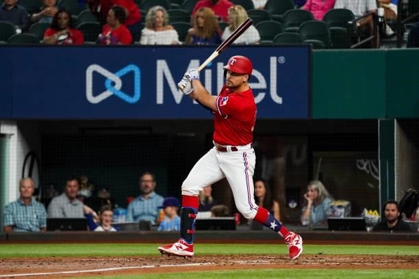 Nate Lowe of the Texas Rangers hits a triple scoring 2 in the bottom of the 4th inning of the game against the Kansas City Royals at Globe Life Field...