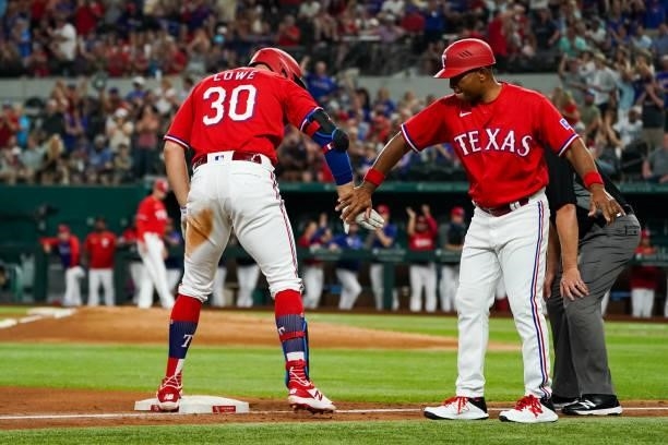 Nate Lowe of the Texas Rangers celebrates with Tony Beasley of the Texas Rangers after hitting a triple scoring 2 in the bottom of the 4th inning of...
