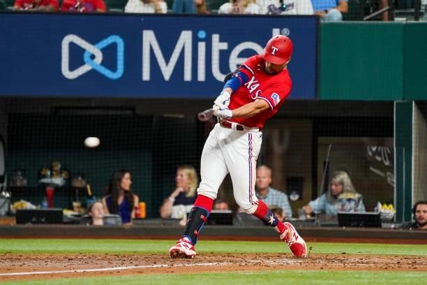 Nate Lowe of the Texas Rangers hits a run scoring single in the bottom of the 5th inning of the game against the Kansas City Royals at Globe Life...