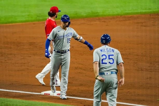 Whit Merrifield of the Kansas City Royals celebrates a run scoring triple in the 3rd inning of the game against the Texas Rangers at Globe Life Field...