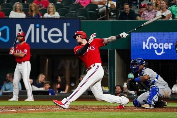 Jonah Heim of the Texas Rangers hits a run scoring single during the top of the 4th inning of the game against the Kansas City Royals at Globe Life...