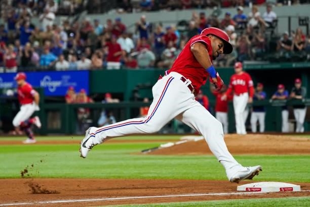 Andy Ibanez of the Texas Rangers round third base after Nate Lowe hits a triple scoring 2 in the bottom of the 4th inning of the game against the...