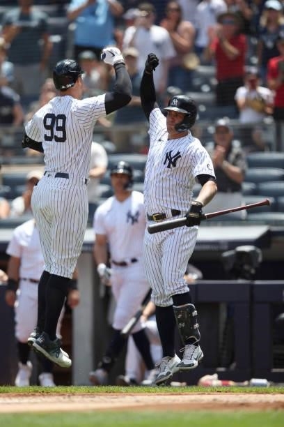 Aaron Judge of the New York Yankees celebrates with Gary Sánchez after hitting a home run during the game between the Kansas City Royals and the New...