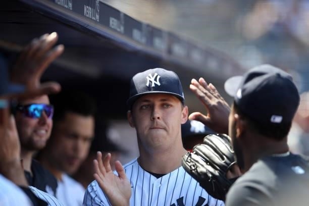 Jameson Taillon of the New York Yankees celebrates in the dugout during the game between the Kansas City Royals and the New York Yankees at Yankee...