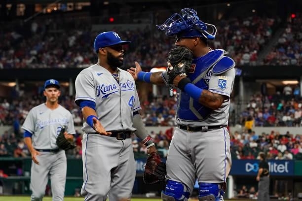 Salvador Perez talks to Carlos Santana of the Kansas City Royals after the top of the 5th inning of the game against the Texas Rangers at Globe Life...