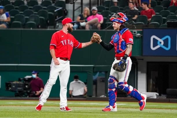 Spencer Patton and Jonah Heim of the Texas Rangers celebrate after the final out of the game against the Kansas City Royals at Globe Life Field on...