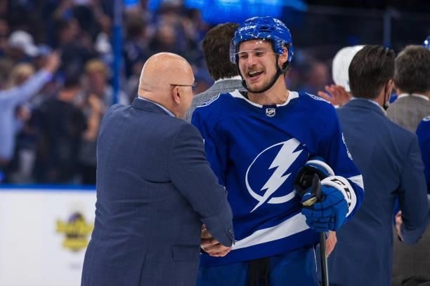 Yanni Gourde of the Tampa Bay Lightning shakes hands with Head Coach Barry Trotz of the New York Islanders after the series win in Game Seven of the...