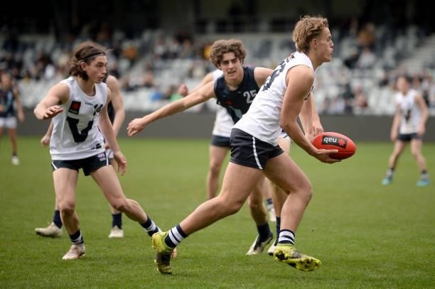 George Stevens of Vic Country handballs during the U17 Championships match between Vic Country and Vic Metro at GMHBA Stadium on June 26, 2021 in...